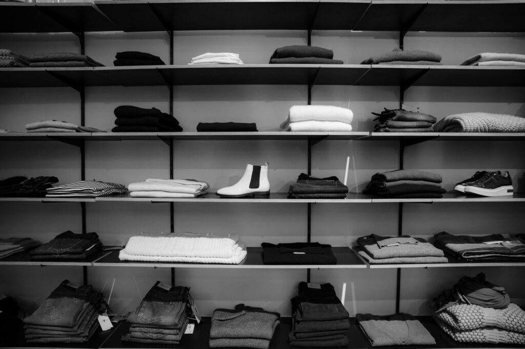 pexels-photo-1884581 grayscale photography of assorted apparels on shelf rack